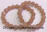 CGB4588 7.5 inches 10mm - 11mm round sunstone beaded bracelets