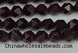 CNG7275 15.5 inches 6mm faceted nuggets red garnet beads