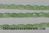 CRU165 15.5 inches 5*8mm faceted rice green rutilated quartz beads